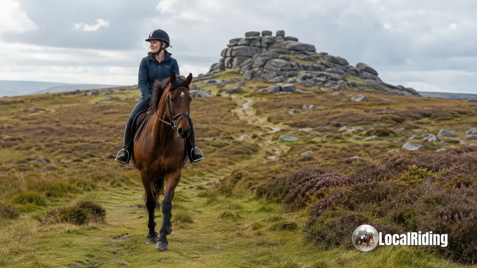 Horse and rider on open moorland on Dartmoor with granite tor in the background, Devon